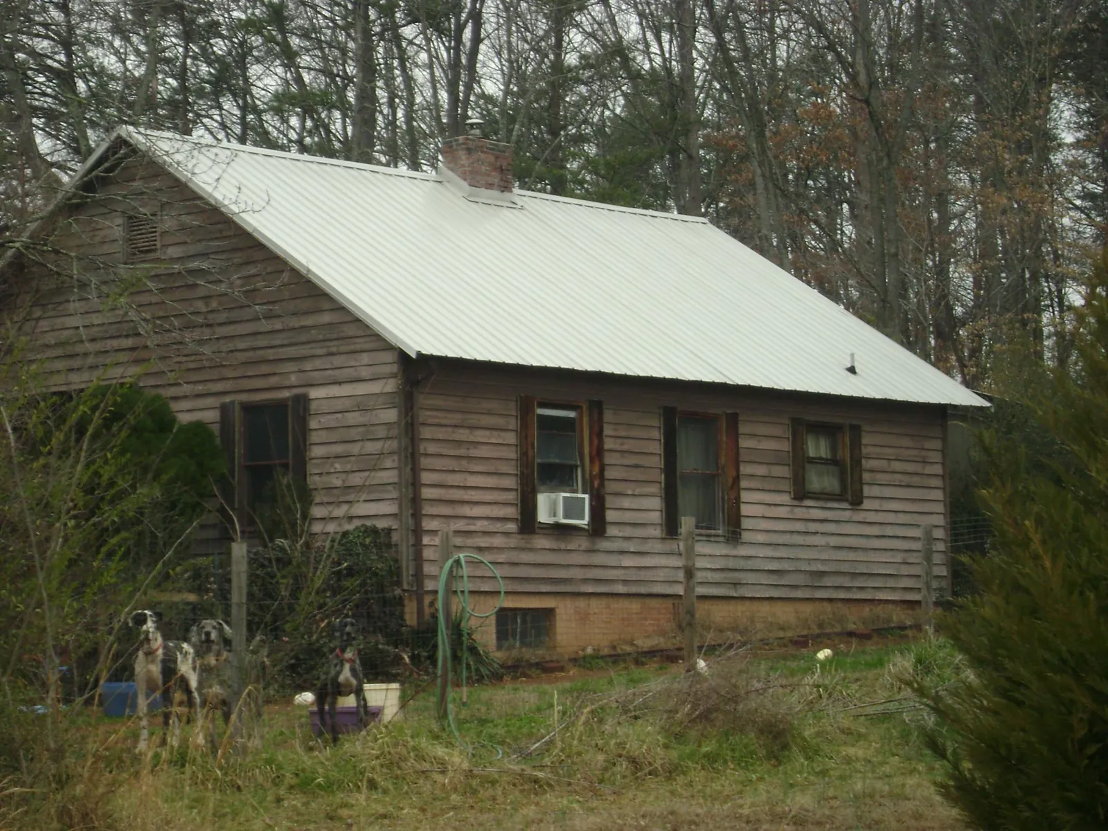 White metal roof on an old wood sided farmhouse, from a Metal Roof Installation job in Topanga